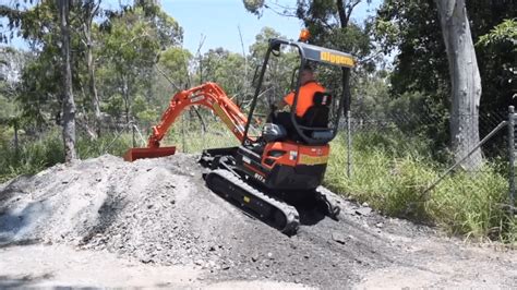 climbing a slope with a mini excavator|mini excavator climbing slope.